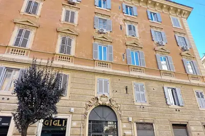 a large brick building with an arch in front of it at Vatican Luxury Apartment in Rome