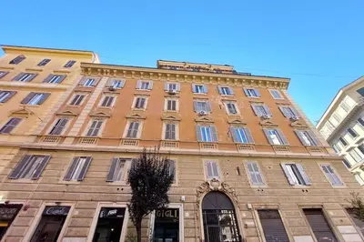 a large brick building with windows on a street at Vatican Luxury Apartment in Rome