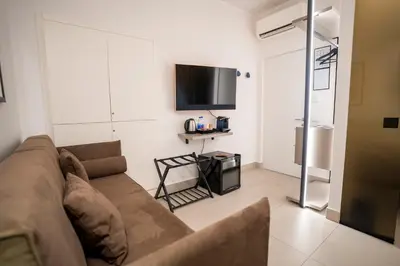 a living room with a couch and a tv at Cicerone's Luxury Suites in Rome