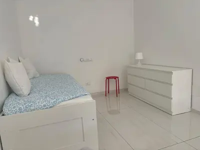 a white bedroom with a bed and a dresser at GIUBILEO PALACE Inn in Rome