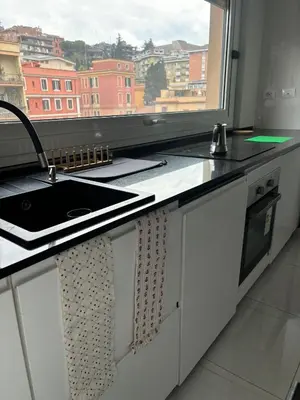 a kitchen counter with a sink and a window at GIUBILEO PALACE Inn in Rome