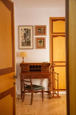 a room with a desk with a chair and a lamp at Ficus Corner - Vatican in Rome