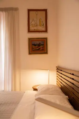 a bedroom with a bed and a picture on the wall at Ficus Corner - Vatican in Rome