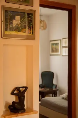 a statue of a rabbit on a shelf next to a bedroom at Ficus Corner - Vatican in Rome