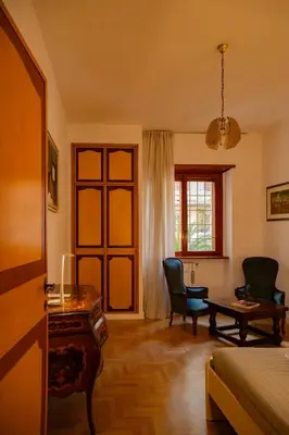 a bedroom with a desk and chairs and a bed at Ficus Corner - Vatican in Rome