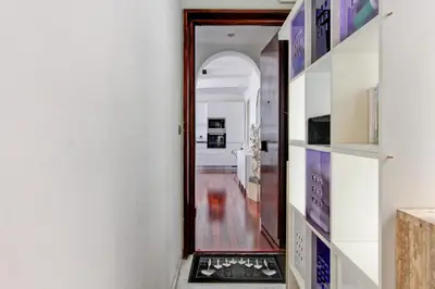 a hallway with a door leading into a room with a kitchen at Cherry in Rome in Rome