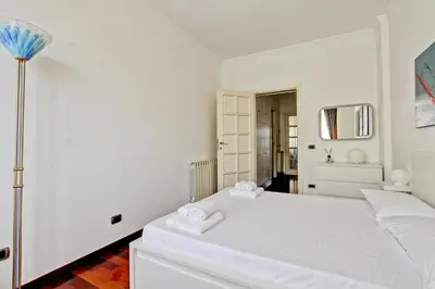 a white bedroom with a white bed with two towels at Cherry in Rome in Rome