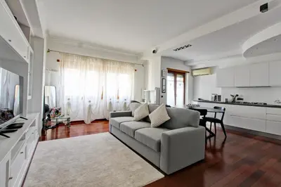 a living room with a couch and a kitchen at Cherry in Rome in Rome