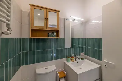a bathroom with a white toilet and a sink at San Peter's Country House in Rome