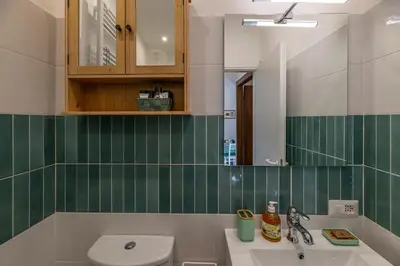 a bathroom with a sink and a toilet and a mirror at San Peter's Country House in Rome