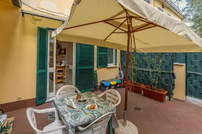 a table with an umbrella on a patio at San Peter's Country House in Rome