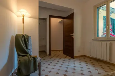 a room with a chair and a window and a door at San Peter's Country House in Rome