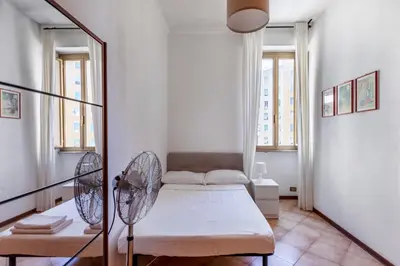 a small room with a bed and a fan at giovanni house roma in Rome