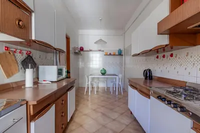 a kitchen with a counter and a table in it at giovanni house roma in Rome