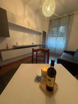 a bottle of wine on a table in a living room at Casa Città del Vaticano in Rome