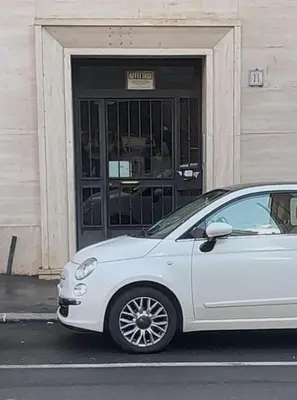 a white car parked in front of a building at Casa Città del Vaticano in Rome