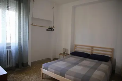 a bedroom with a bed and a window at Casa Fiore in Rome