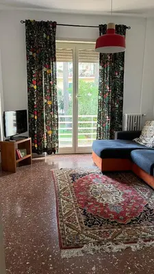 a living room with a couch and a large window at Casa Fiore in Rome