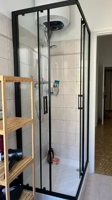 a shower with a glass door in a bathroom at Casa Fiore in Rome