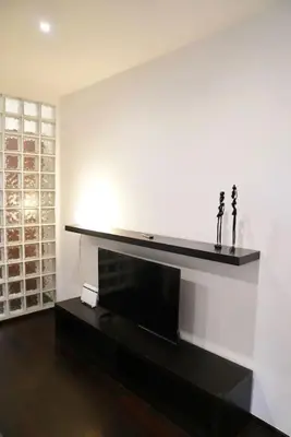 a living room with a fireplace and a white wall at Piramide Experience in Rome