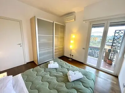 a bedroom with a large bed with two towels on it at Piramide Experience in Rome