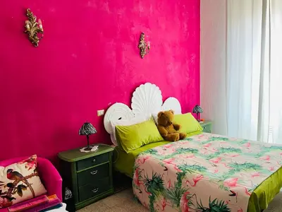 a pink bedroom with a bed with a teddy bear on it at Home Sweet Rome Vatican in Rome