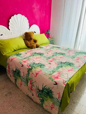 a teddy bear sitting on top of a bed at Home Sweet Rome Vatican in Rome