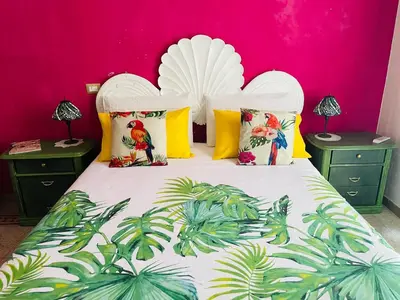 a bedroom with a white bed with a pink wall at Home Sweet Rome Vatican in Rome