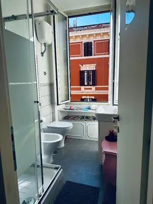 a bathroom with a toilet and a sink and a window at Home Sweet Rome Vatican in Rome
