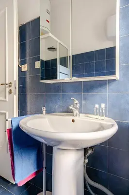 a bathroom with a white sink and a mirror at Daisy Home - Tiburtina loft in Rome WiFi in Rome