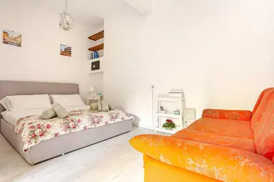a bedroom with a bed and a couch at Daisy Home - Tiburtina loft in Rome WiFi in Rome