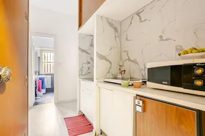 a kitchen with a microwave on top of a counter at Daisy Home - Tiburtina loft in Rome WiFi in Rome