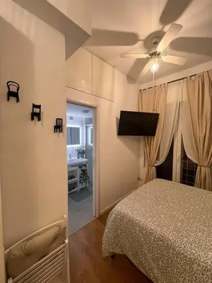 a bedroom with a bed and a ceiling fan at Vatican Almond Tree Penthouse in Rome