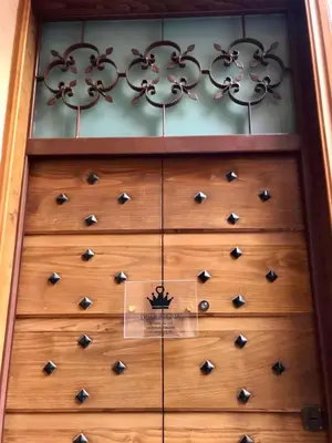 a wooden door with a bunch of knobs on it at Domus Gaia in Rome
