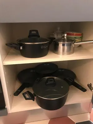 three pots and pans on a shelf in a kitchen at Domus Gaia in Rome