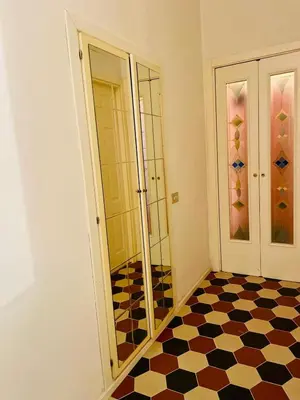 a bathroom with a checkered floor and glass doors at Domus Gaia in Rome