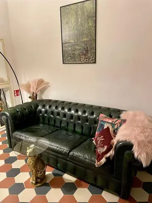 a black leather couch in a living room at Domus Gaia in Rome