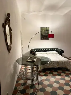 a bedroom with a bed and a glass table at Domus Gaia in Rome