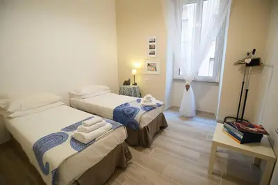 a room with two beds and a window at Alloggio Machiavelli 59 in Rome