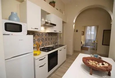 a kitchen with a white refrigerator and a stove top oven at Alloggio Machiavelli 59 in Rome