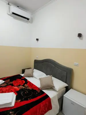 a bedroom with a bed with a red flower blanket at RATTAZZI ROMA CENTRo in Rome
