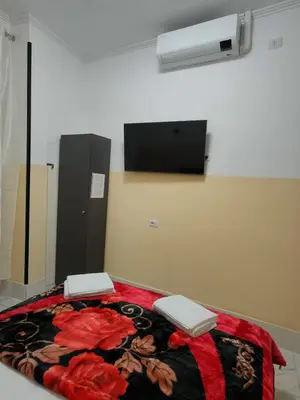 a room with a bed with a blanket and a fan at RATTAZZI ROMA CENTRo in Rome