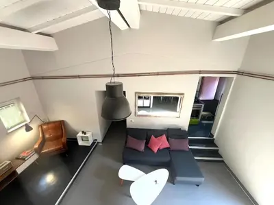 a small room with a couch and a table at Stylish duplex with terrace Rome in Rome