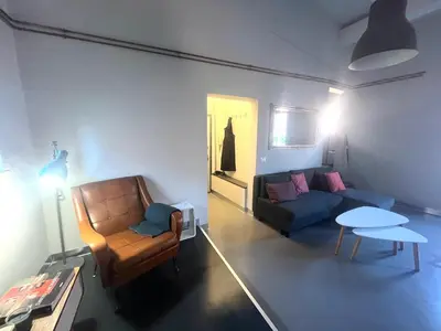 a living room with a couch and a chair at Stylish duplex with terrace Rome in Rome