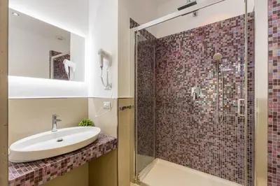 a bathroom with a sink and a glass shower at Merulana 43 - Guest House in Rome