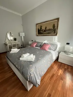a bedroom with a large bed and a mirror at ALGA Roma in Rome