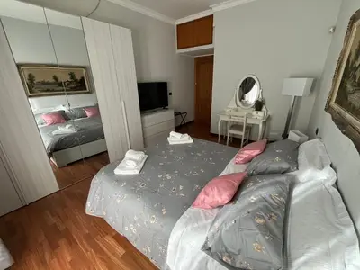 a bedroom with a bed and a television in it at ALGA Roma in Rome