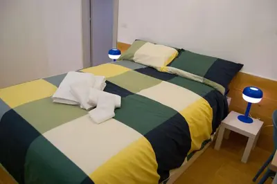 a bedroom with a bed with a colorful blanket at Breathe Romance San Giovanni in Rome