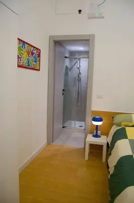 a bedroom with a bed and a bathroom with a shower at Breathe Romance San Giovanni in Rome