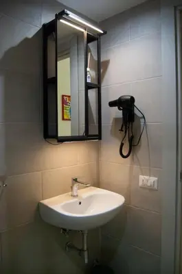 a bathroom with a sink and a mirror on the wall at Breathe Romance San Giovanni in Rome